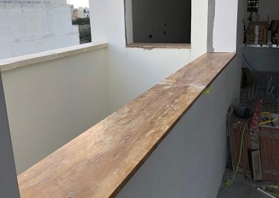 Travertine window sill installed in dining area