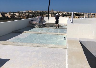 First load of concrete being poured onto the roof