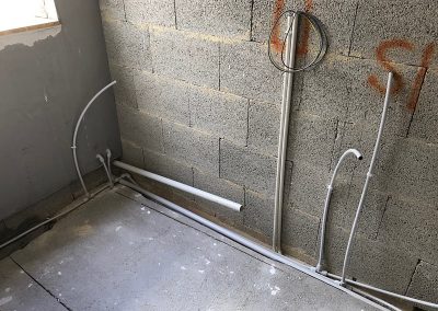 Water pipes and drainage pipes being installed in the guest en-suite