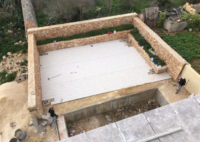 The developer's guy's getting on with tiling the pool area