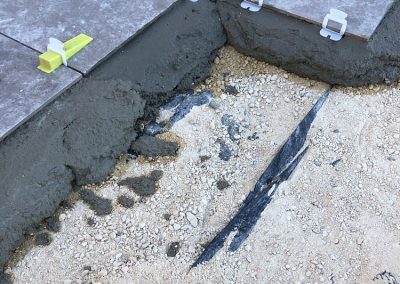 The amount of concrete under each tile - you can just see a membrane layer