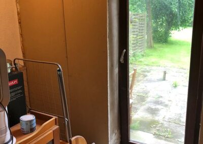 Living room before - plaster board and exposed cement