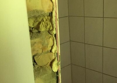 Bathroom door frame onto shower area - before